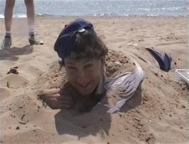 Michael's after-lunch treat was to be buried in the sand, apparently